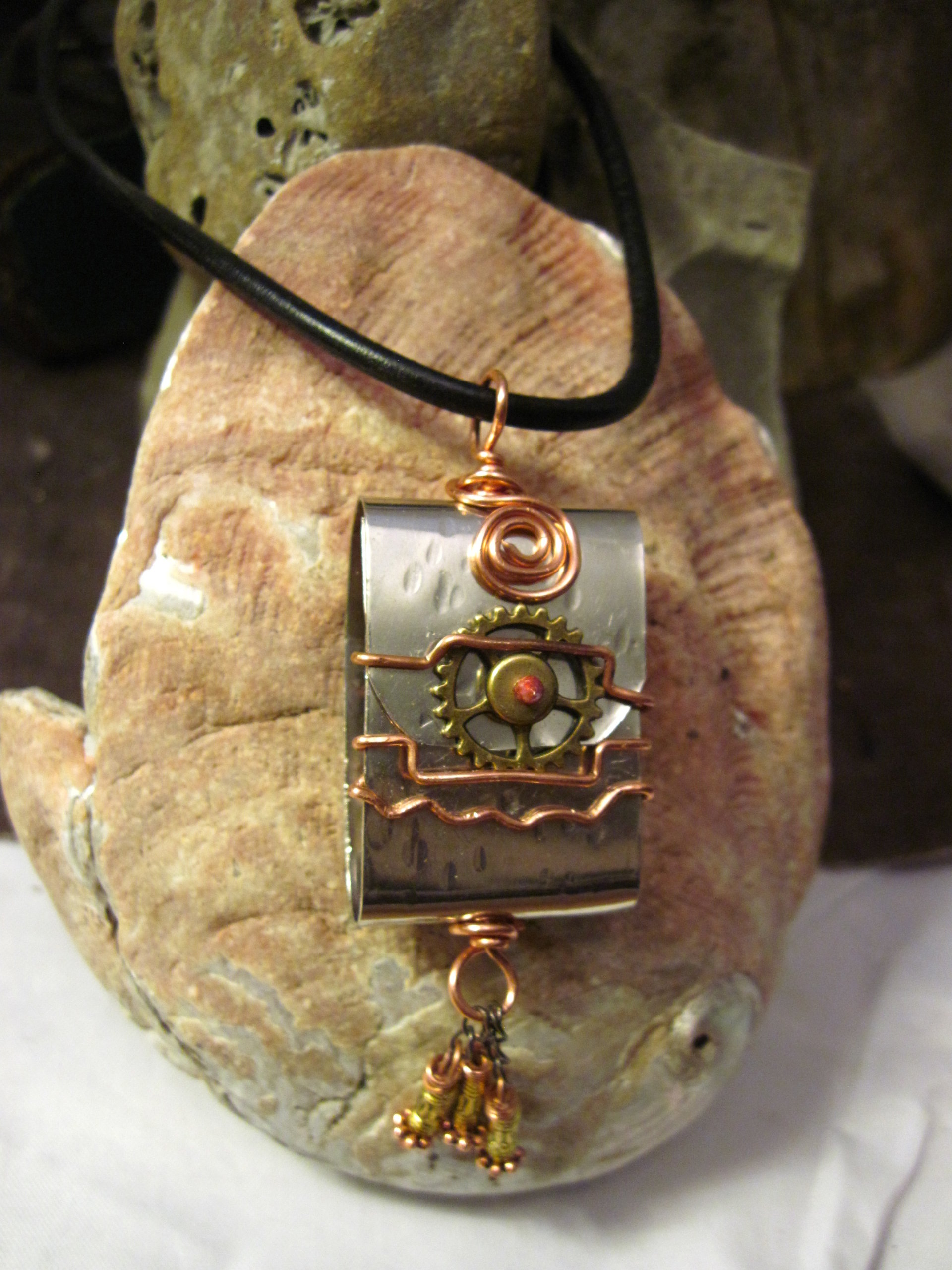 Zen prayer pendant of mixed metals with word wisdom inside