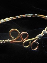 Upper Arm cuff bracelet of copper, brass, and silver wire.