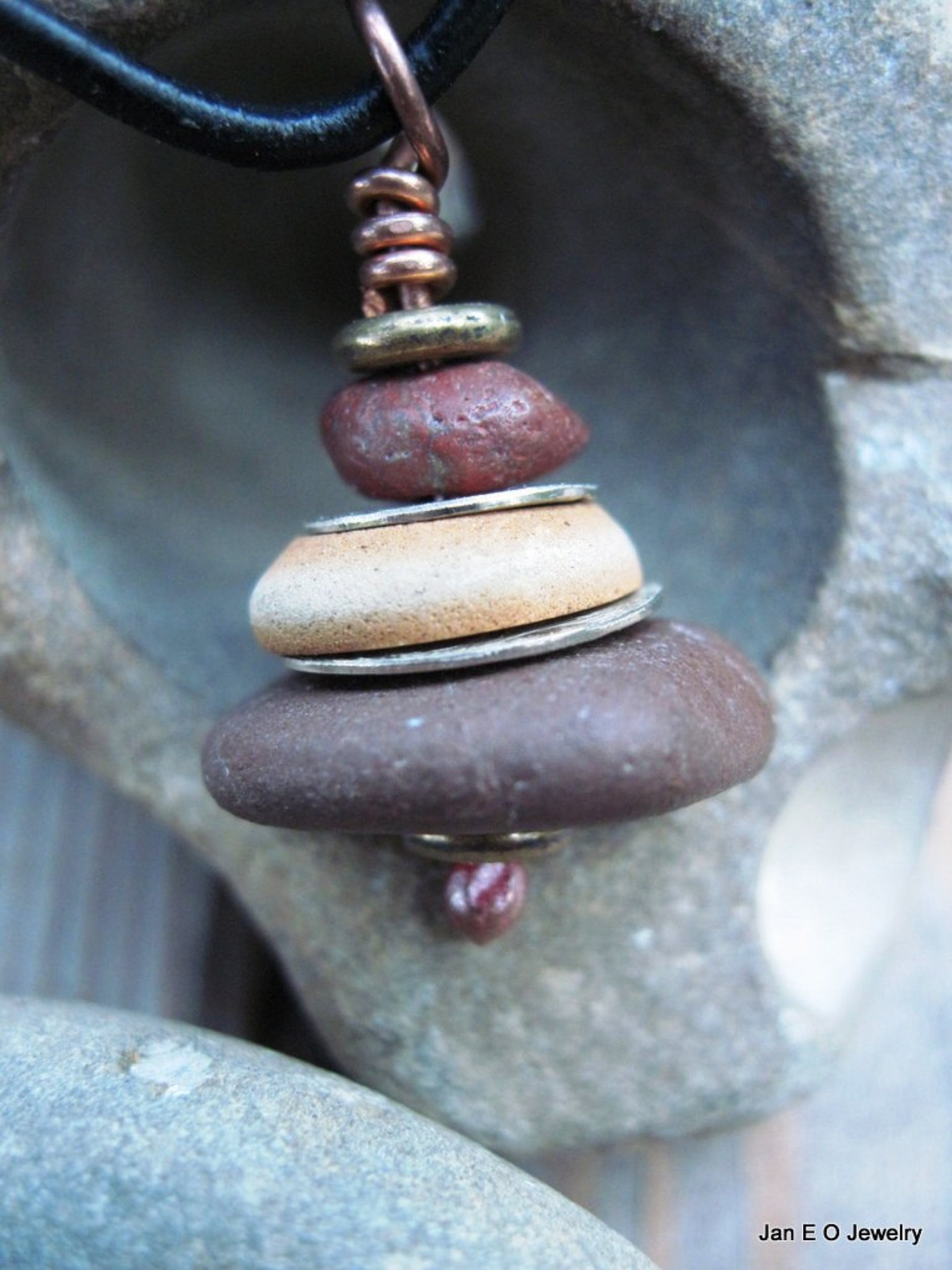 Om stacked beach rock cairn in brown tones Pacific NW beach stones