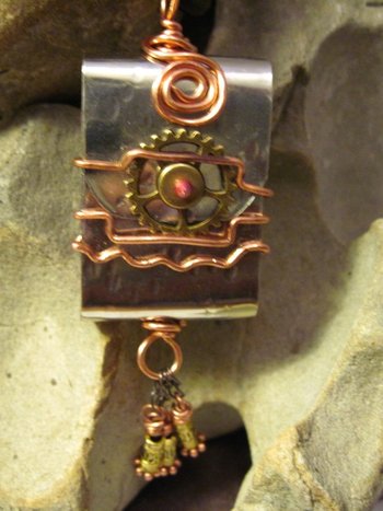 Zen prayer pendant of mixed metals with word wisdom inside